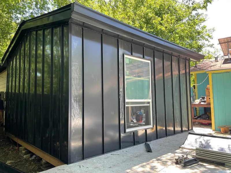 Black standing seam metal wall panels for Roof Inspection in North Bend